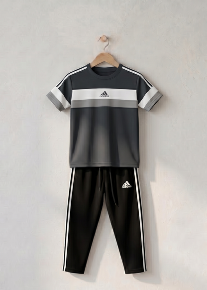 Black and gray children's tracksuit on a wooden hanger against a light gray background