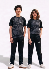 Two people wearing matching black and gray camouflage outfits on a white background