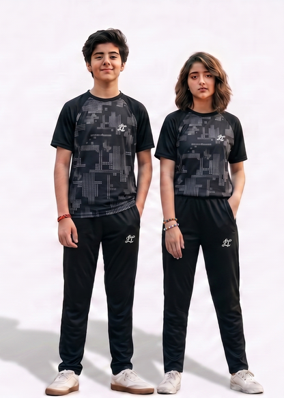 Two people wearing matching black and gray camouflage outfits on a white background