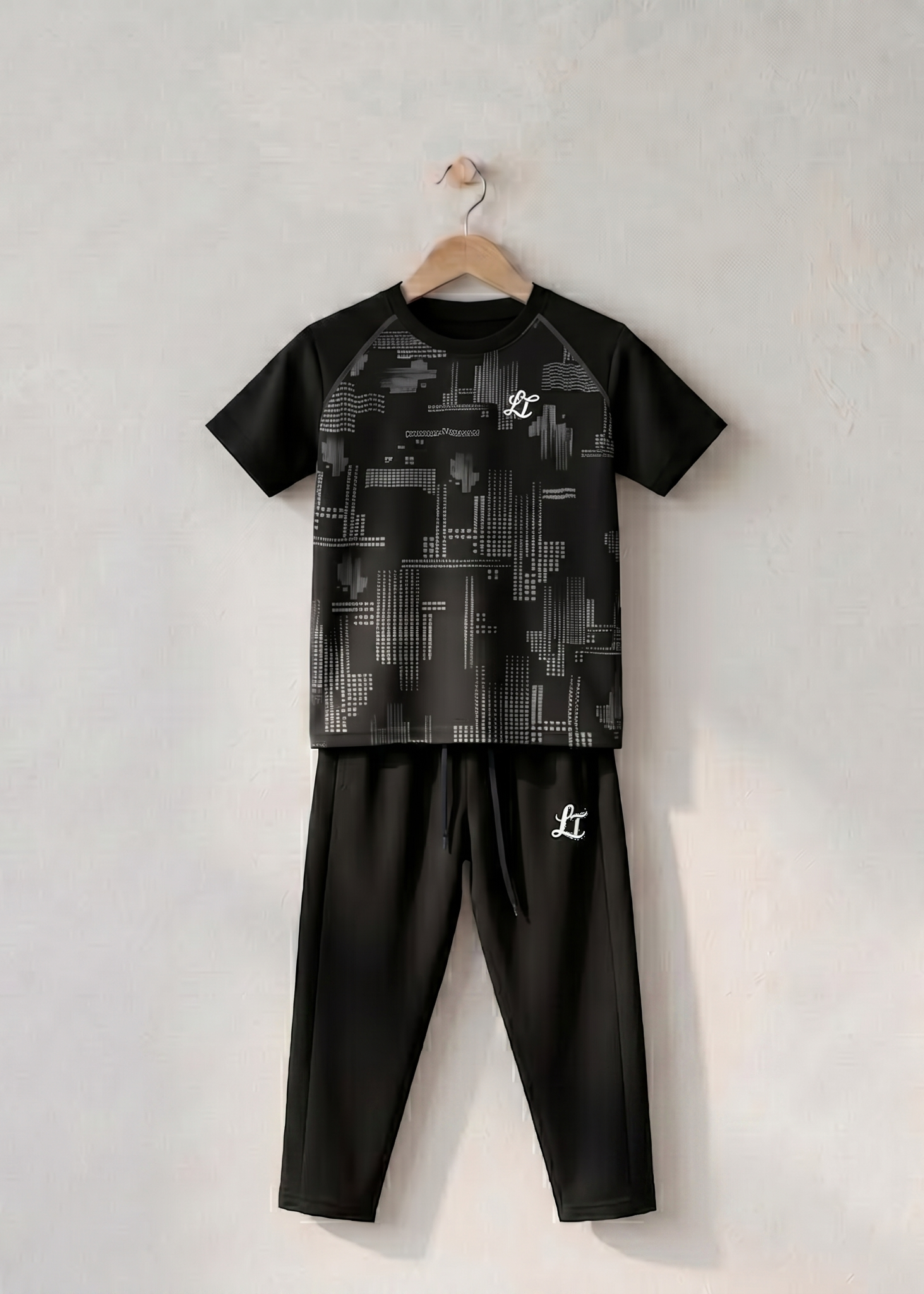 Black and gray children's outfit with geometric pattern on a white background